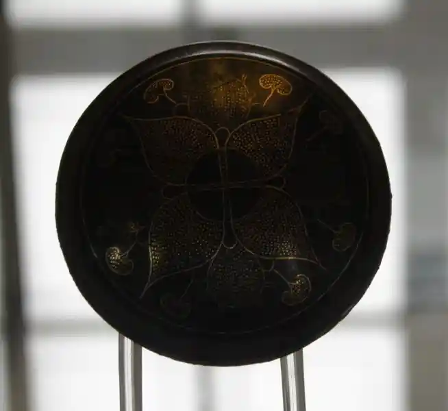 Cross inside a circle derived from a flower-like symbol on a bronze inlaid horse fitting